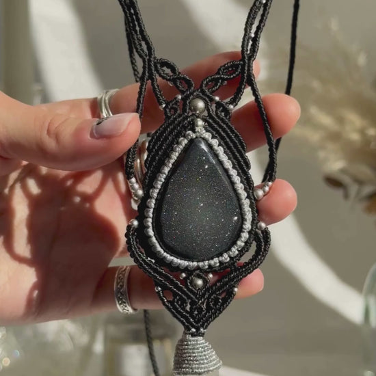 Video of a handmade Druzy Onyx and Clear Quartz point macrame necklace. Displaying natural gemstone colors, light reflections, and fine macrame details.