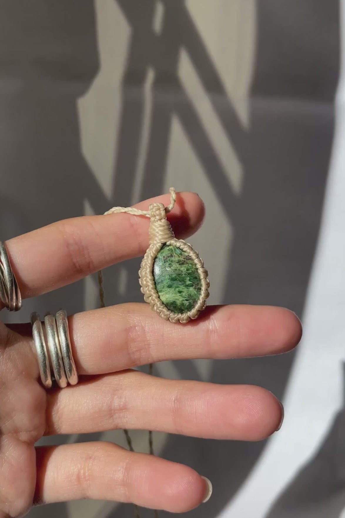 Video of the handmade Ruby Fuchsite Macrame necklace, highlighting the ruby details and the deep green tones of the gemstone, as the lightweight, minimalist macrame design.