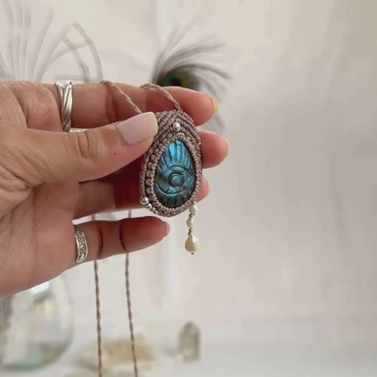 Video of Labradorite protective eye necklace, showing shifting blue hues and natural labradorescence of the gemstone, and the Fresh Water Pearl accents dangling.