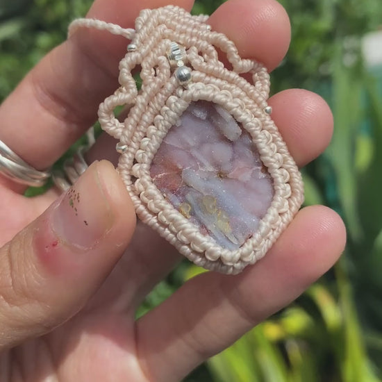 Close-up video of a handmade gemstone necklace, capturing the natural shine and intricate details of Raw Pink Chalcedony Stalactite. The unique design and polished gemstones reflect the light beautifully, highlighting the craftsmanship and one-of-a-kind artistry.