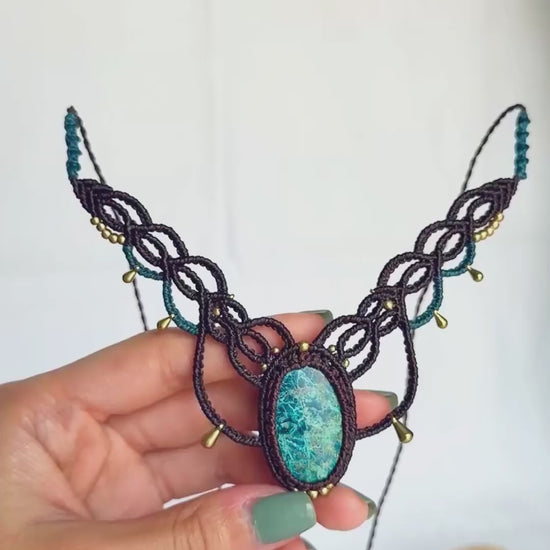 Video showing the chrysocolla stone’s blue-green colours and intricate natural veining in its brown macrame setting.