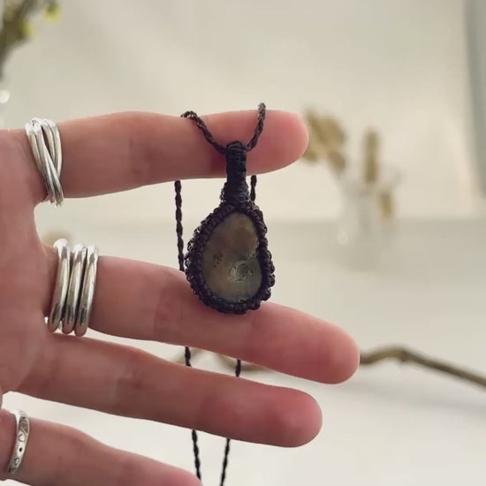 Handmade Ammonite macramé necklace showing natural fossil details, texture and shine
