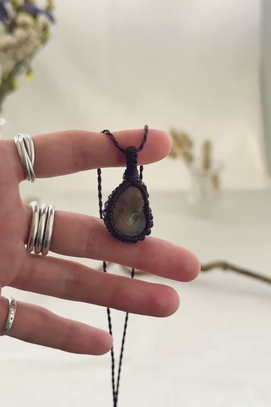Handmade Ammonite macramé necklace showing natural fossil details, texture and shine