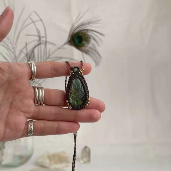 Video of Labradorite protective eye necklace, showing shifting multicolor hues and natural labradorescence of the gemstone, accented with Prehnite and golden beads.