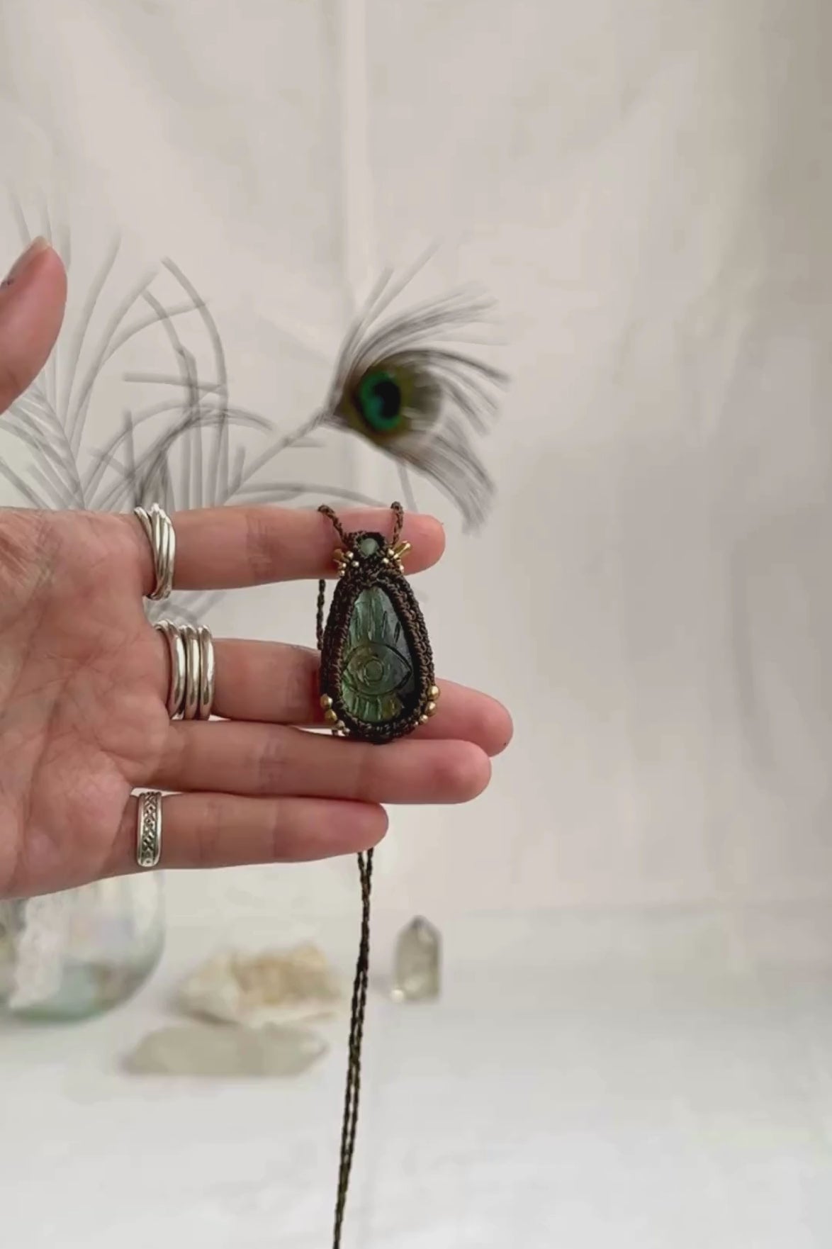 Video of Labradorite protective eye necklace, showing shifting multicolor hues and natural labradorescence of the gemstone, accented with Prehnite and golden beads.