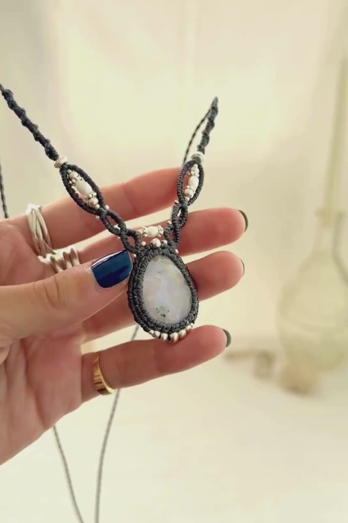 Video showing the movement and natural shine of a Moonstone macramé necklace with Freshwater Pearl details