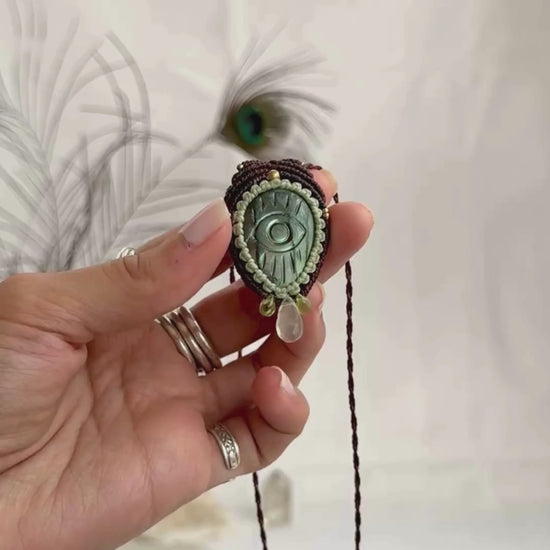 Video of Labradorite protective eye necklace, showing shifting green hues and natural labradorescence of the gemstone, accented with Epidote and Prehnite drops.