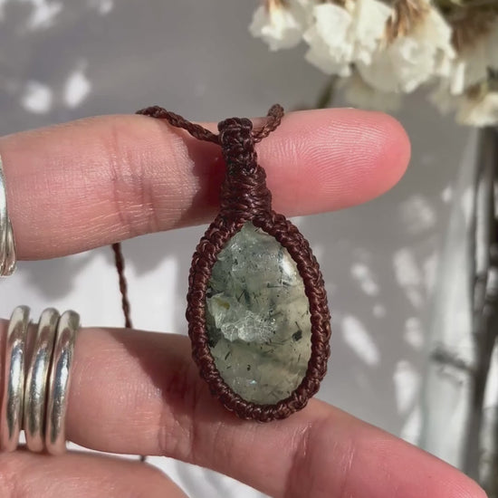 Video of a handmade Prehnite macrame necklace, capturing the soft green gemstone’s natural glow and the intricate macrame knotting.