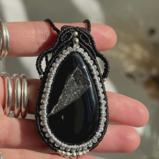 Video of a handmade Druzy Onyx macrame necklace. Displaying natural gemstone colors, light reflections, and fine macrame details.