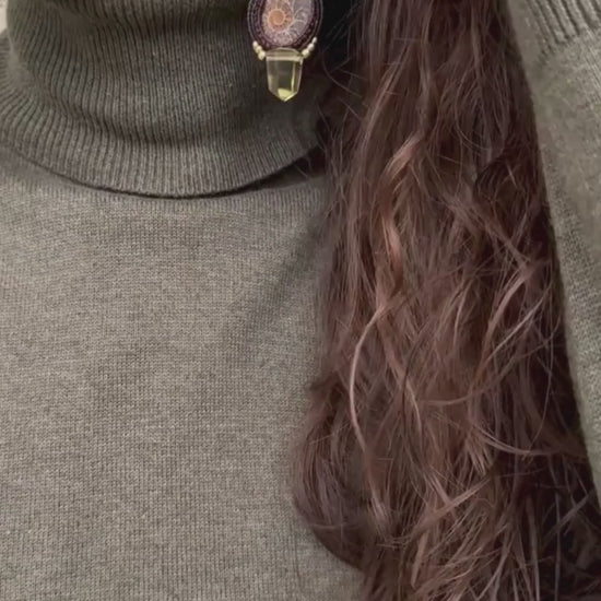 Sliced ammonite earrings in motion, showing dangling smoky quartz and freshwater pearls, highlighting fluidity and lightness