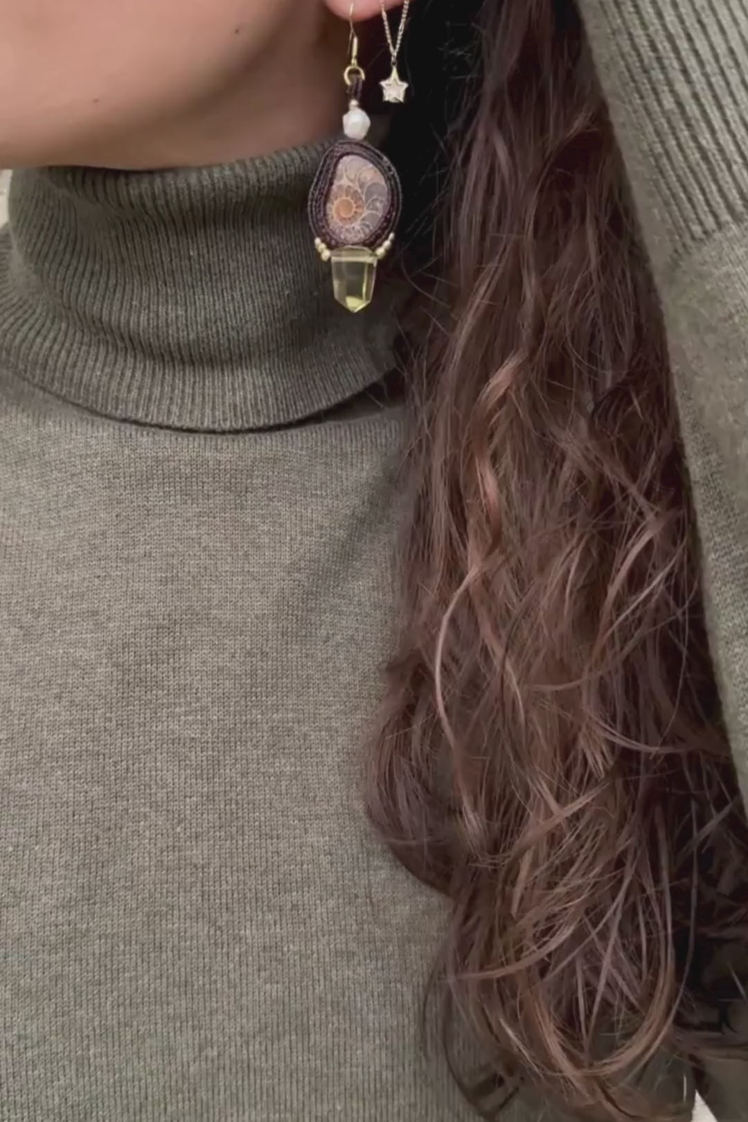 Sliced ammonite earrings in motion, showing dangling smoky quartz and freshwater pearls, highlighting fluidity and lightness