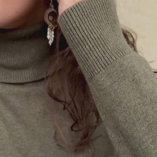 Sliced ammonite earrings in motion, highlighting flowing freshwater pearl drops, ammonite detail, and lightweight design