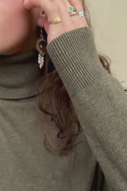 Sliced ammonite earrings in motion, highlighting flowing freshwater pearl drops, ammonite detail, and lightweight design