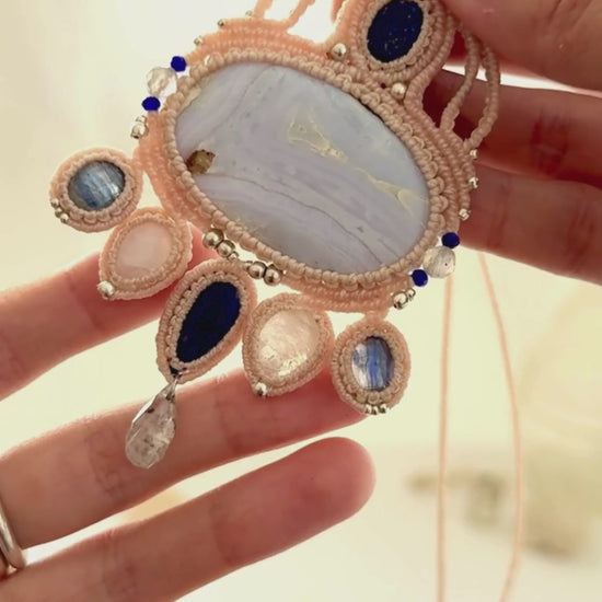 Video showing a one of a kind gemstone macrame statement necklace with flowing movement and natural gemstone shine