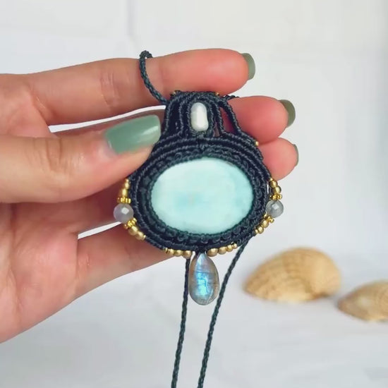 Close-up video of the Larimar and Labradorite macrame necklace, showing the stones’ details and the shifting flashes of the faceted Labradorite.