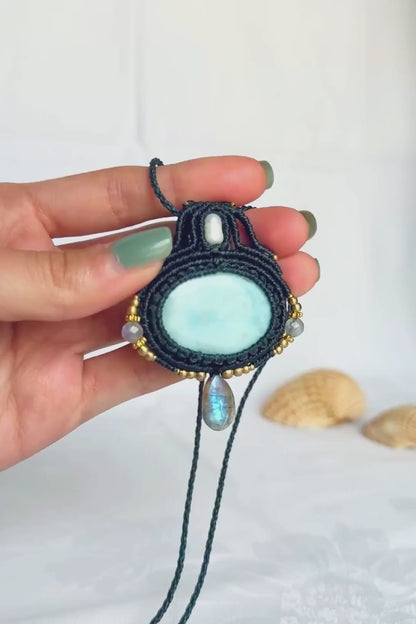 Close-up video of the Larimar and Labradorite macrame necklace, showing the stones’ details and the shifting flashes of the faceted Labradorite.