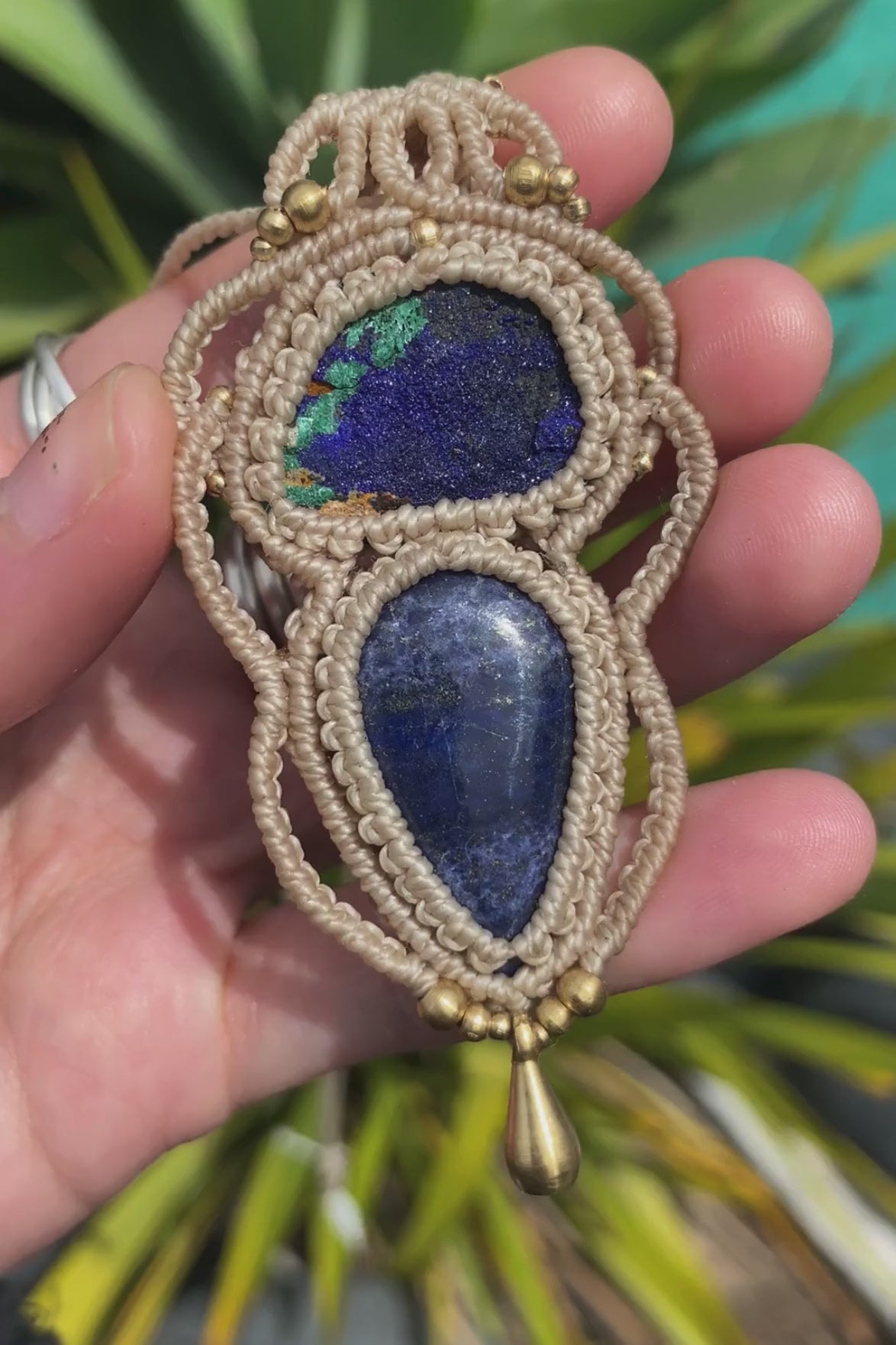 Close-up video of a handmade gemstone necklace, capturing the natural shine and intricate details of Raw Azurite and Lapis Lazuli. The unique design and polished gemstones reflect the light beautifully, highlighting the craftsmanship and one-of-a-kind artistry.