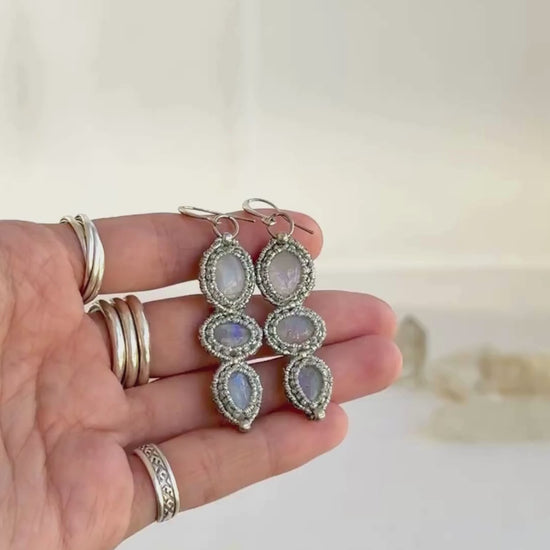 Video showcasing the handmade macrame earring design with three Moonstone gemstones each. Showing the glow of the gemstones, the intricate macrame work and the unique design.
