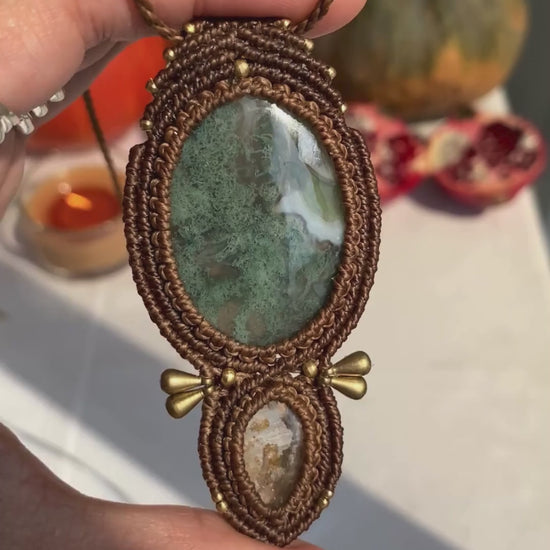 Close-up video of a handmade gemstone necklace, capturing the natural shine and intricate details of Moss Agate and Lodolite. The unique design and polished gemstones reflect the light beautifully, highlighting the craftsmanship and one-of-a-kind artistry.