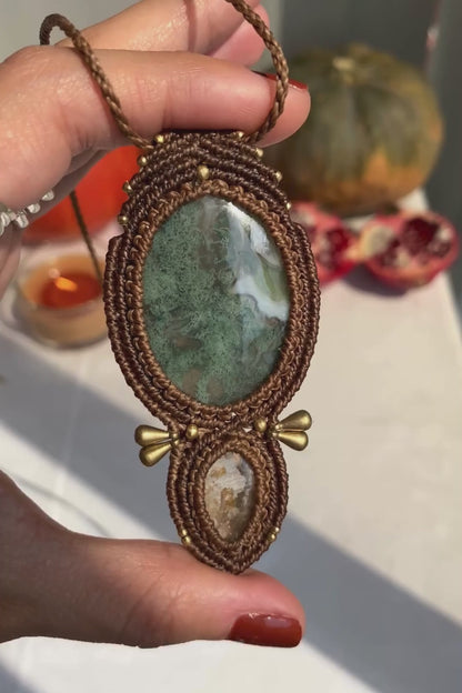 Close-up video of a handmade gemstone necklace, capturing the natural shine and intricate details of Moss Agate and Lodolite. The unique design and polished gemstones reflect the light beautifully, highlighting the craftsmanship and one-of-a-kind artistry.