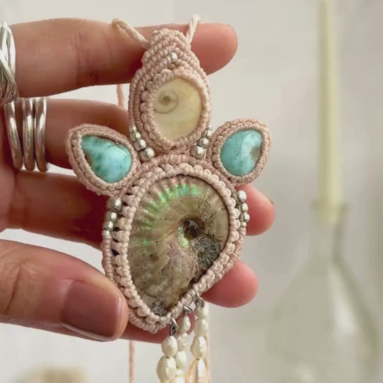 Opalized ammonite necklace showcasing iridescent shine and flowing freshwater pearl drops