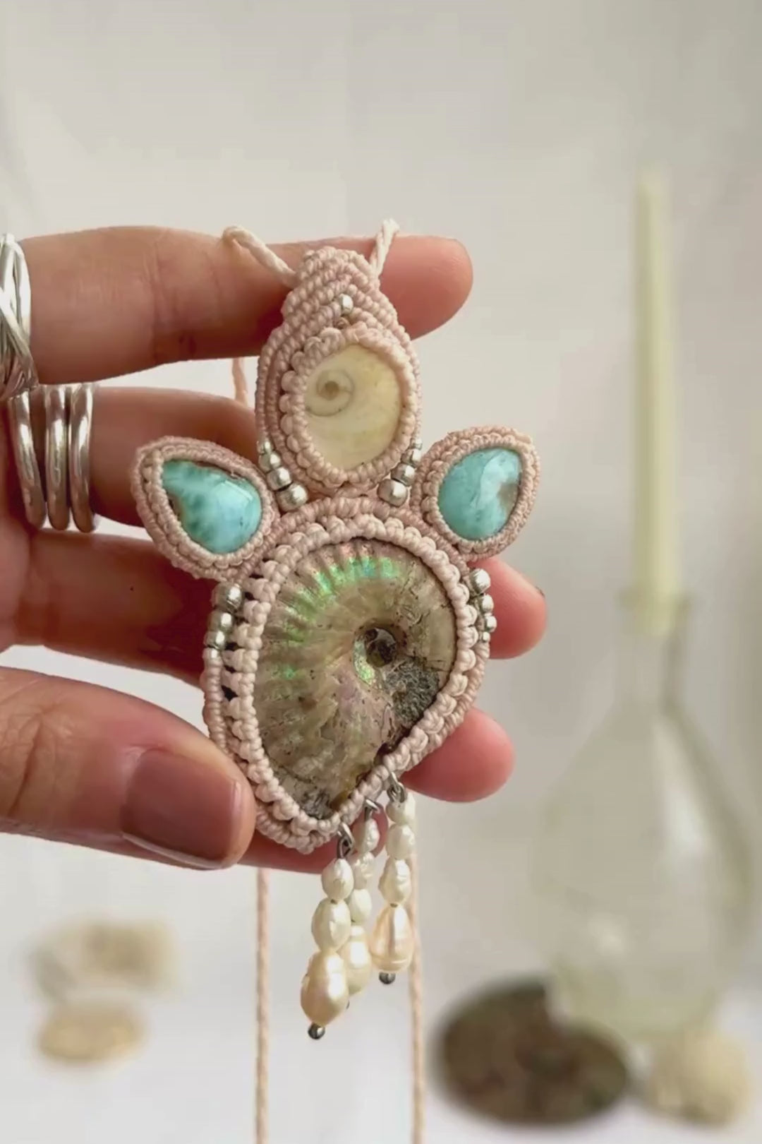 Opalized ammonite necklace showcasing iridescent shine and flowing freshwater pearl drops