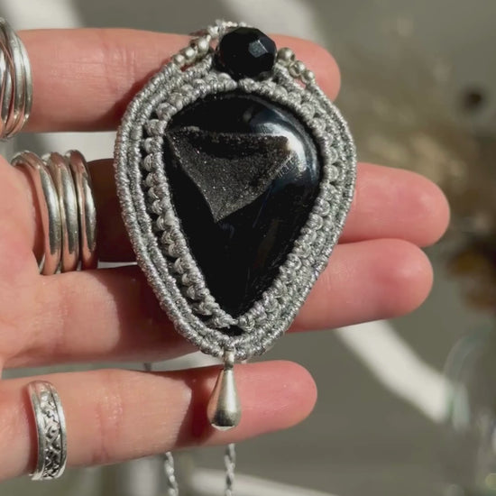 Video of a handmade Druzy Onyx macrame necklace. Displaying natural gemstone colors, light reflections, and fine macrame details.