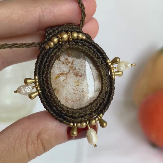 Close-up video of a handmade gemstone necklace, capturing the natural shine and intricate details of Lodolite and Fresh Water Pearls. The unique design and polished gemstones reflect the light beautifully, highlighting the craftsmanship and one-of-a-kind artistry.