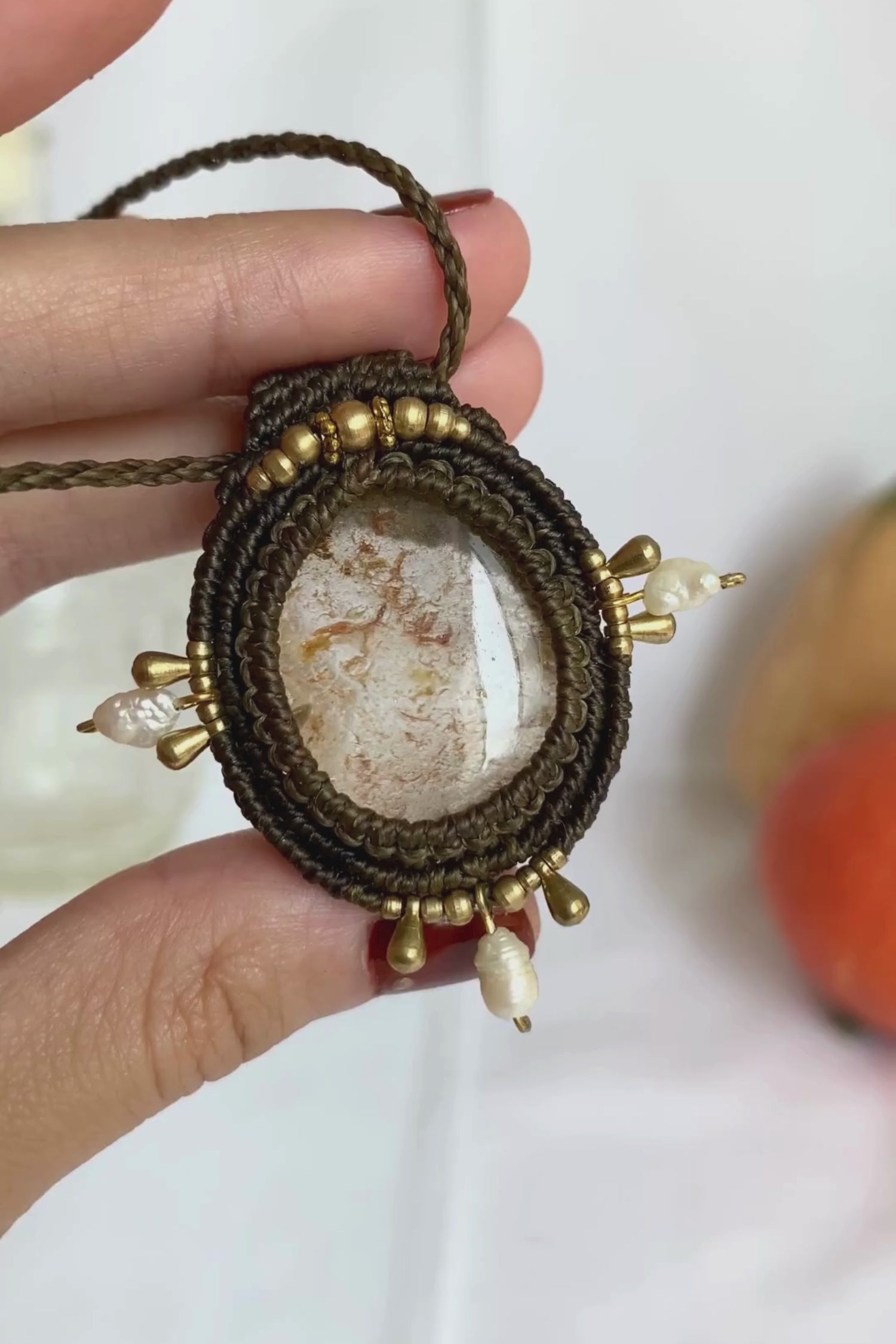 Close-up video of a handmade gemstone necklace, capturing the natural shine and intricate details of Lodolite and Fresh Water Pearls. The unique design and polished gemstones reflect the light beautifully, highlighting the craftsmanship and one-of-a-kind artistry.