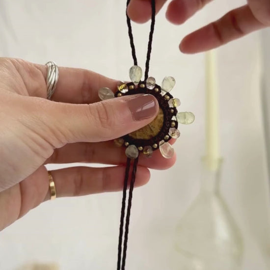 Adjustable sea urchin fossil bolo tie necklace showcasing sliding closure and gemstone details