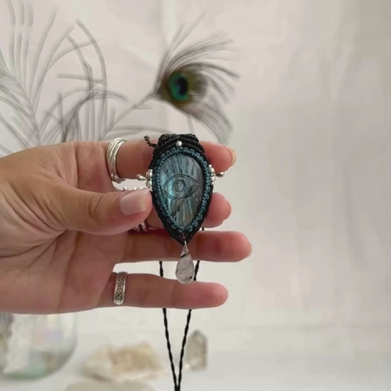 Video of Labradorite protective eye necklace, showing shifting blue hues and natural labradorescence of the gemstone, accented with a dangling Tourmaline Quartz tear.