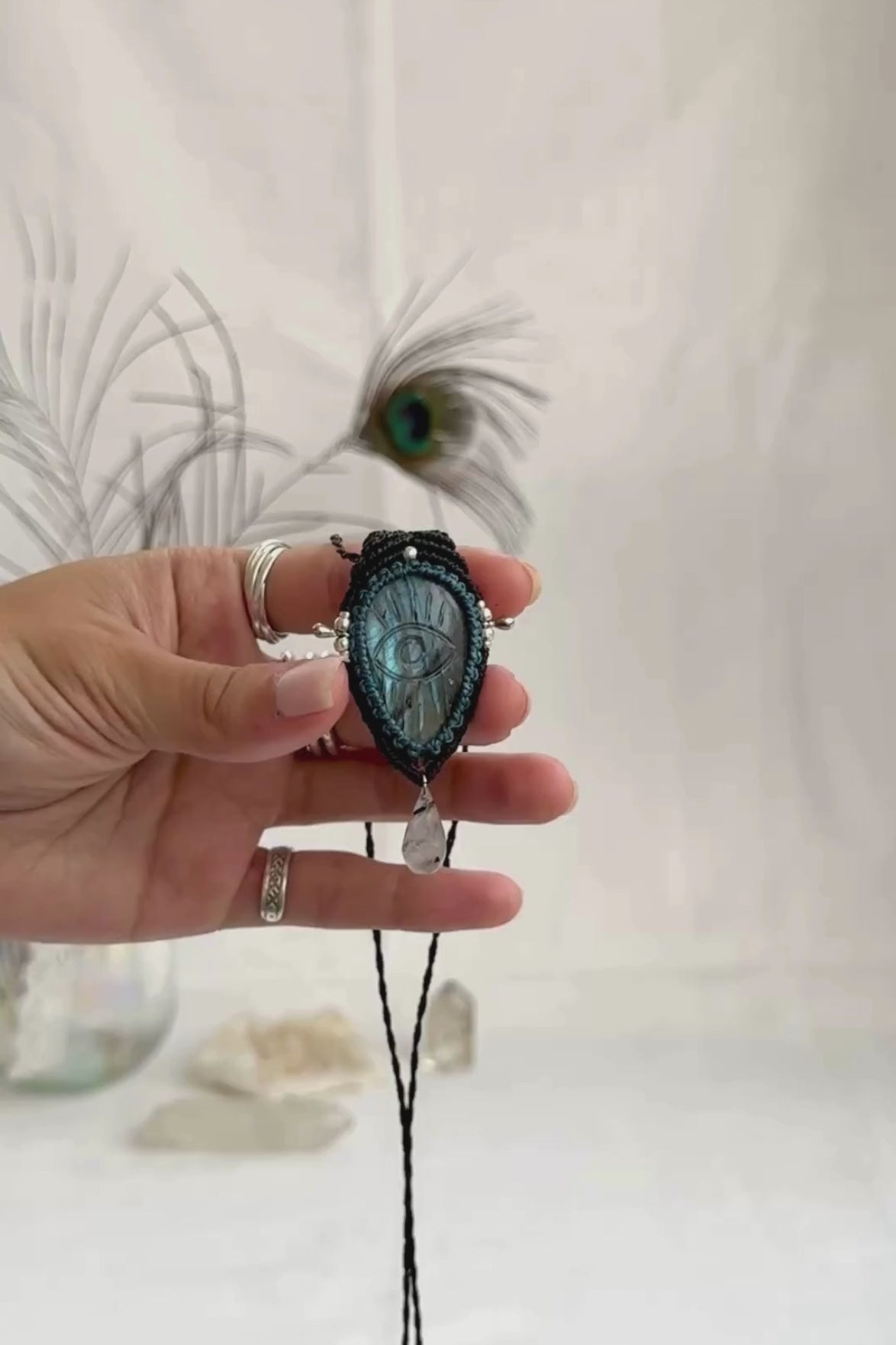 Video of Labradorite protective eye necklace, showing shifting blue hues and natural labradorescence of the gemstone, accented with a dangling Tourmaline Quartz tear.