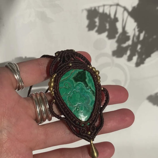 Close-up video of a handmade gemstone necklace, capturing the natural shine and intricate details of Malachite with Chrysocolla. The unique design and polished gemstones reflect the light beautifully, highlighting the craftsmanship and one-of-a-kind artistry.