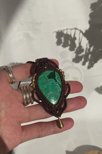 Close-up video of a handmade gemstone necklace, capturing the natural shine and intricate details of Malachite with Chrysocolla. The unique design and polished gemstones reflect the light beautifully, highlighting the craftsmanship and one-of-a-kind artistry.