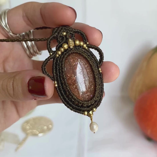 Close-up video of a handmade gemstone necklace, capturing the natural shine and intricate details of Sunstone and Fresh Water Pearl. The unique design and polished gemstones reflect the light beautifully, highlighting the craftsmanship and one-of-a-kind artistry.