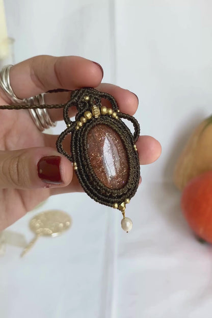 Close-up video of a handmade gemstone necklace, capturing the natural shine and intricate details of Sunstone and Fresh Water Pearl. The unique design and polished gemstones reflect the light beautifully, highlighting the craftsmanship and one-of-a-kind artistry.