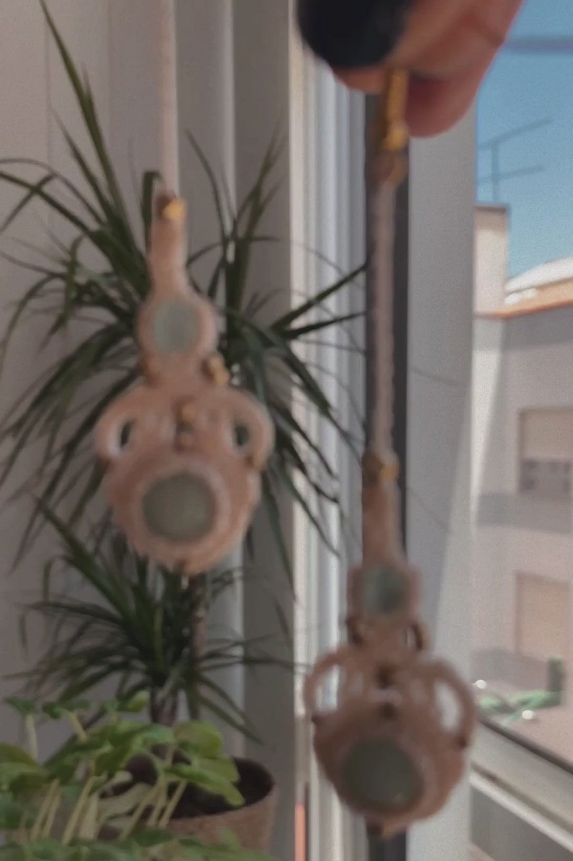 Video showcasing handmade macrame earrings with amazonite and aquamarine gemstones, demonstrating their lightweight feel, elegant movement, and how they shine in light when worn.