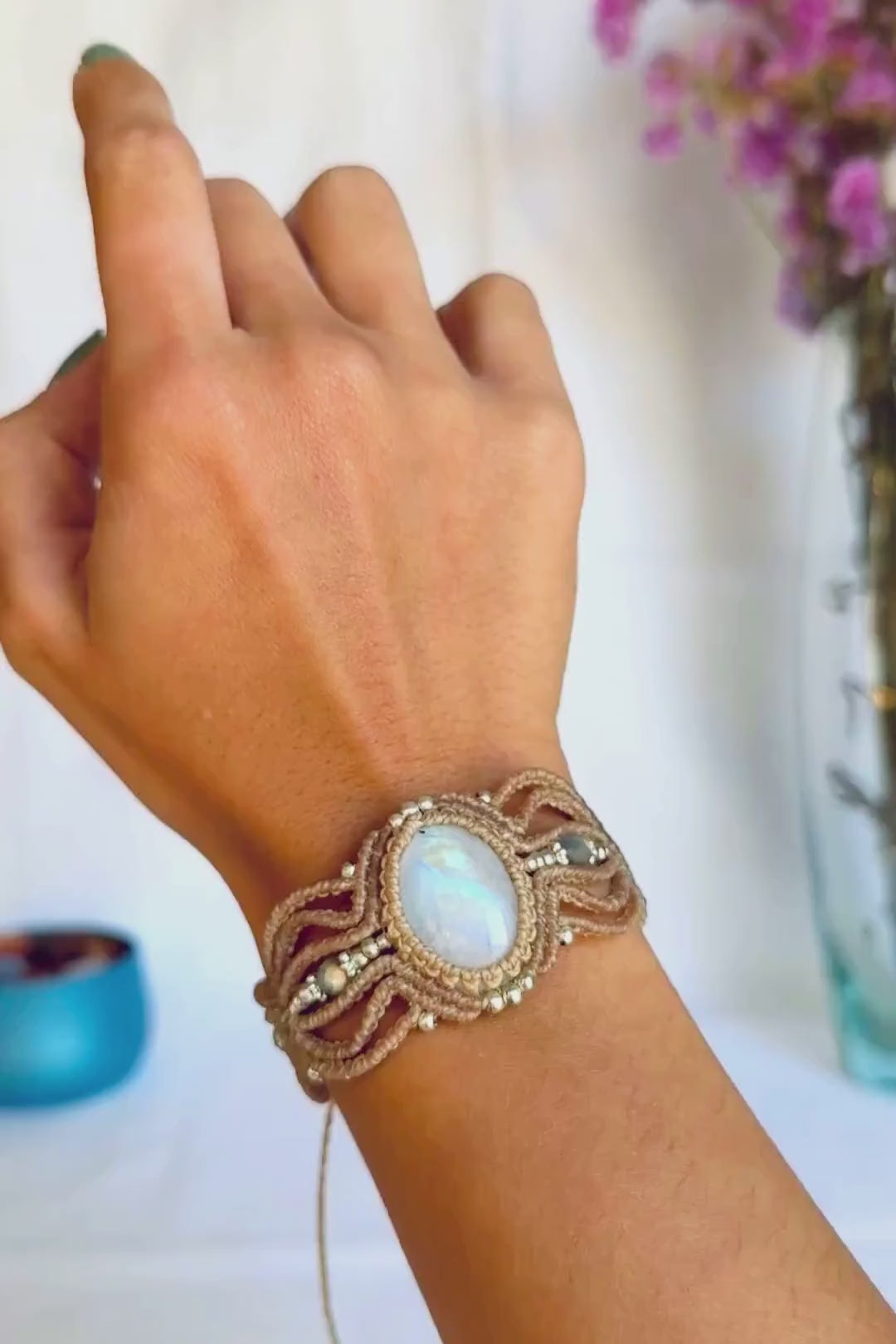 Detailed view of the macrame cuff bracelet, showing the iridescent flashes of the Rainbow Moonstone and faceted Labradorite beads.