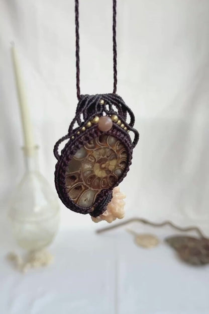 Video showing ammonite fossil necklace with calcite coraloid tentacles, and peach moonstone, highlighting macramé details and fossil texture