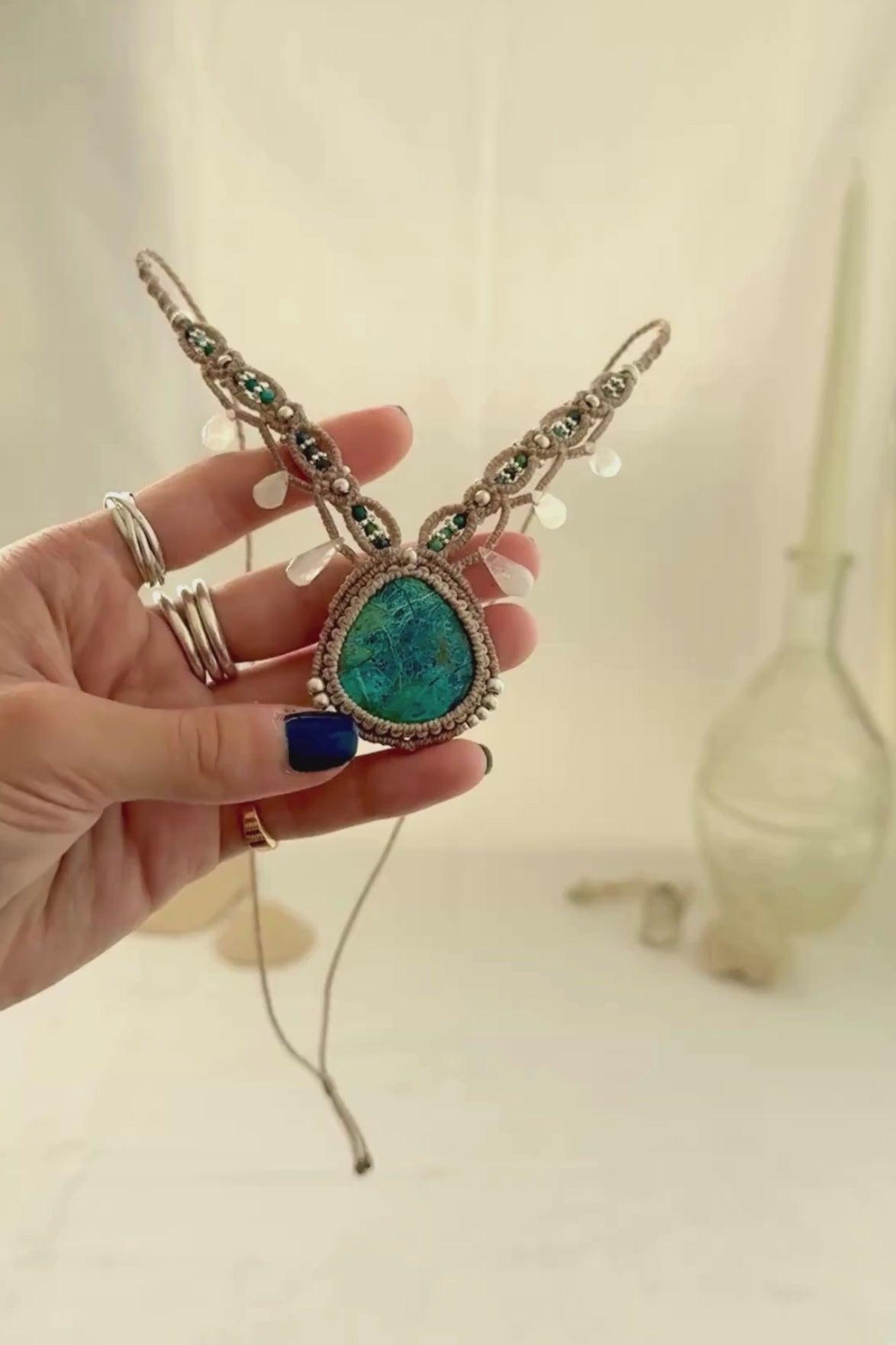 Video showing the movement and natural shine of a Chrysocolla macramé necklace with Azurite and Moonstone details