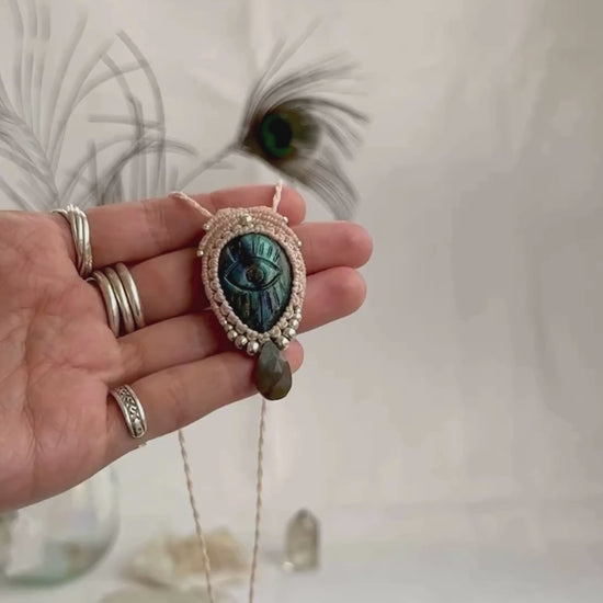 Video of Labradorite protective eye necklace, showing shifting blue hues and natural labradorescence of the gemstone, accented with a faceted Labradorite drop shaped bead.
