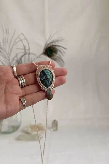 Video of Labradorite protective eye necklace, showing shifting blue hues and natural labradorescence of the gemstone, accented with a faceted Labradorite drop shaped bead.