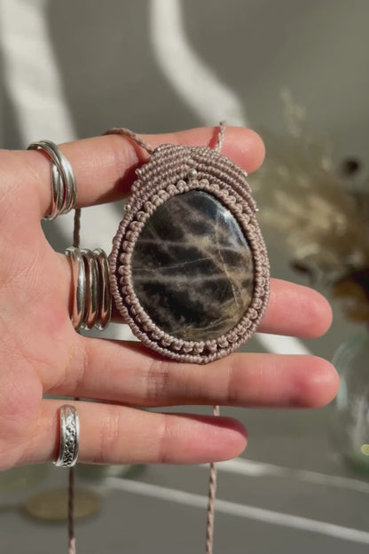 Video of a handmade Black Moonstone macrame necklace. Displaying natural gemstone colors, light reflections, and fine macrame details.
