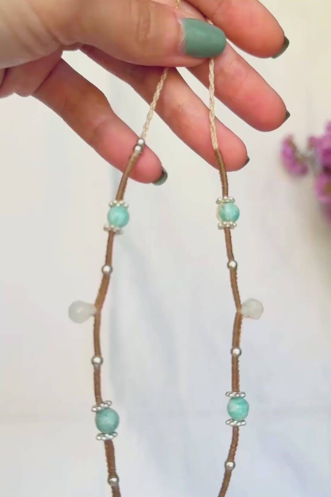 Video showing the Rainbow Moonstone's changing shimmer and the macrame details of the Moonstone and Amazonite necklace.
