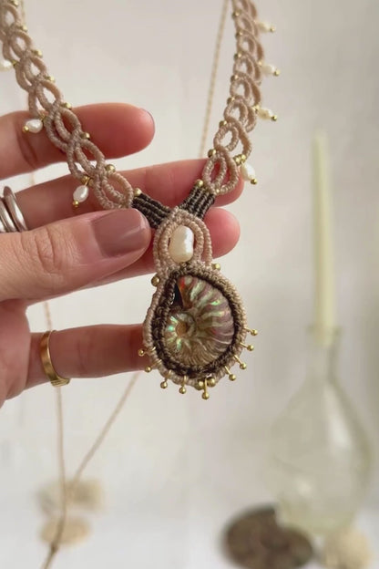 Iridescent ammonite fossil necklace showcasing natural color reflections and pearl details