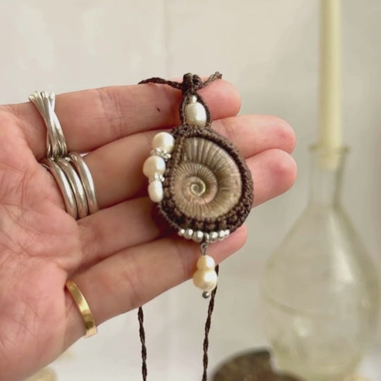 Raw ammonite fossil necklace showcasing natural pearl details and artisan craftsmanship