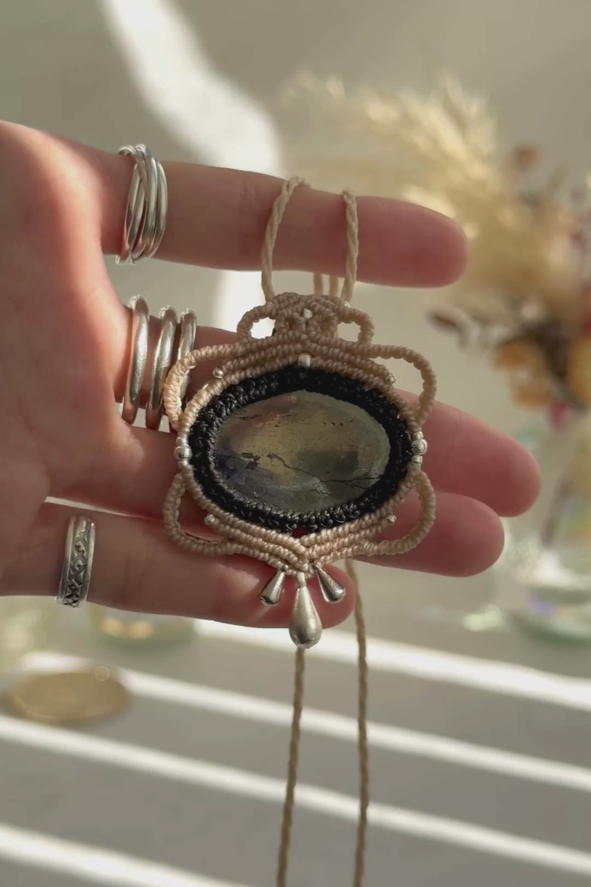 Video of a handmade Pyrite macrame necklace. Displaying natural gemstone colors, light reflections, and fine macrame details.