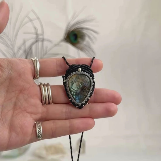 Video of Labradorite protective eye necklace, showing shifting blue hues and natural labradorescence of the gemstone.