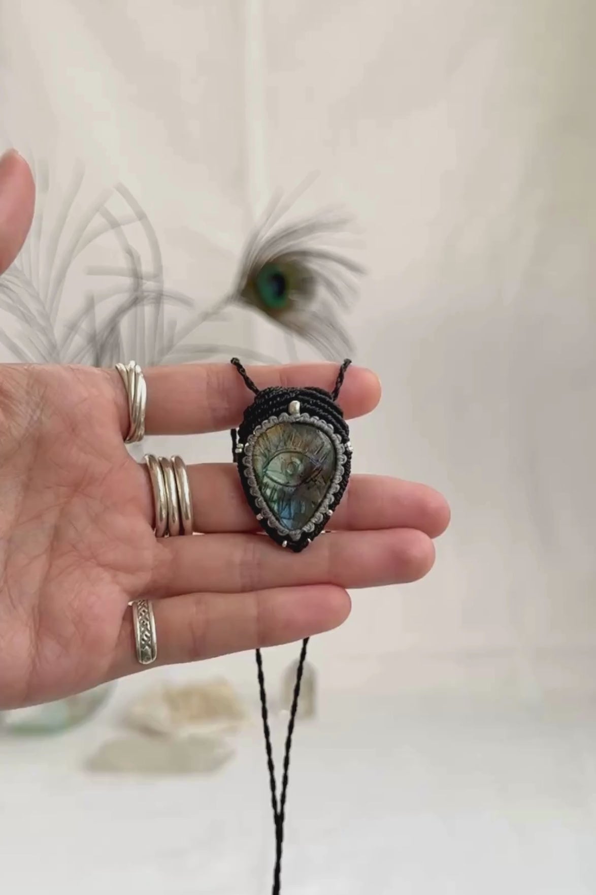 Video of Labradorite protective eye necklace, showing shifting blue hues and natural labradorescence of the gemstone.