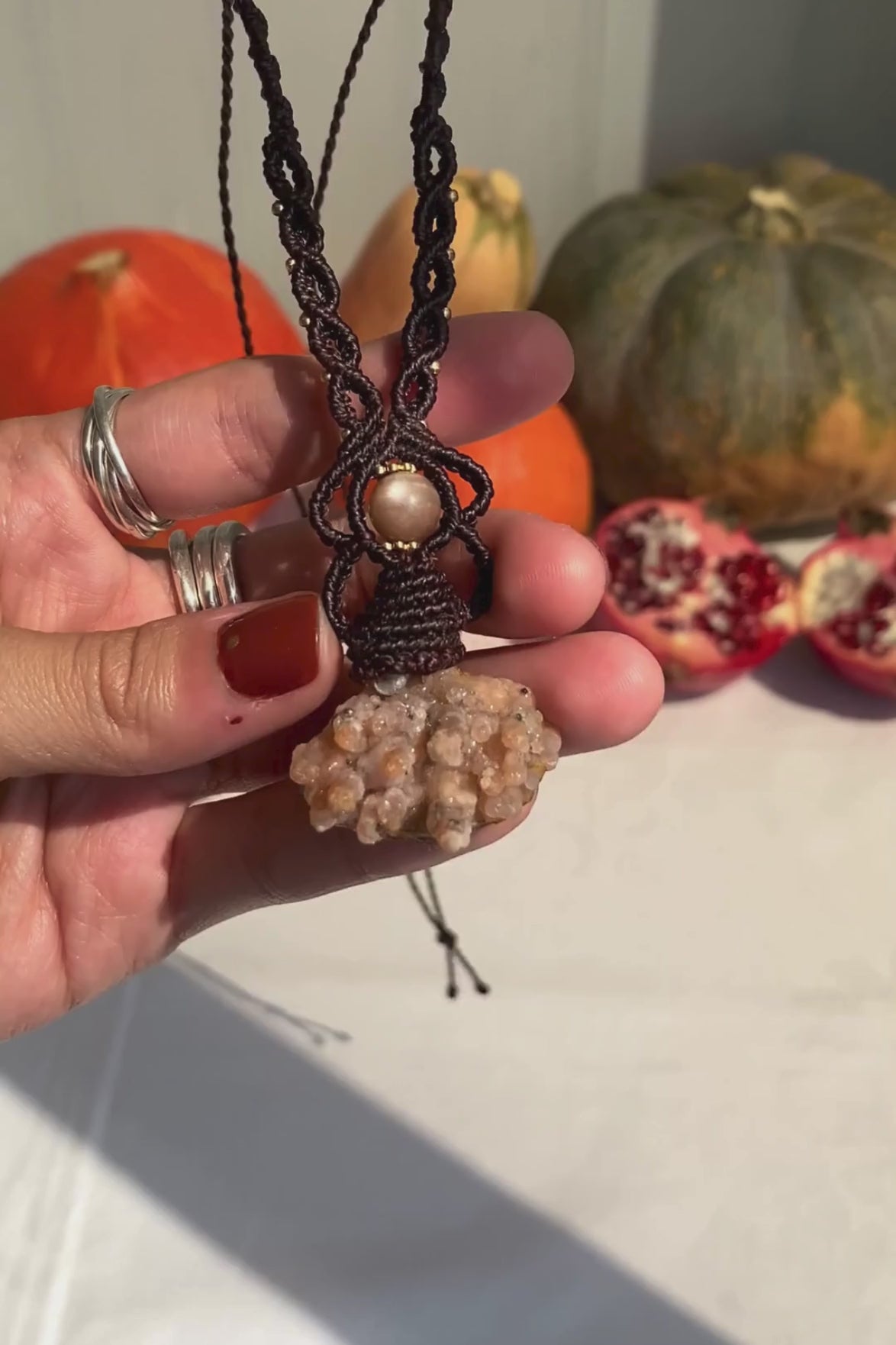 Close-up video of a handmade gemstone necklace, capturing the natural shine and intricate details of Raw Chalcedony and Peach Moonstone. The unique design and polished gemstones reflect the light beautifully, highlighting the craftsmanship and one-of-a-kind artistry.
